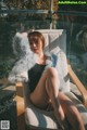 A woman sitting on a chair wearing a fur coat.