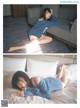 A woman laying on a bed in a blue sweater.