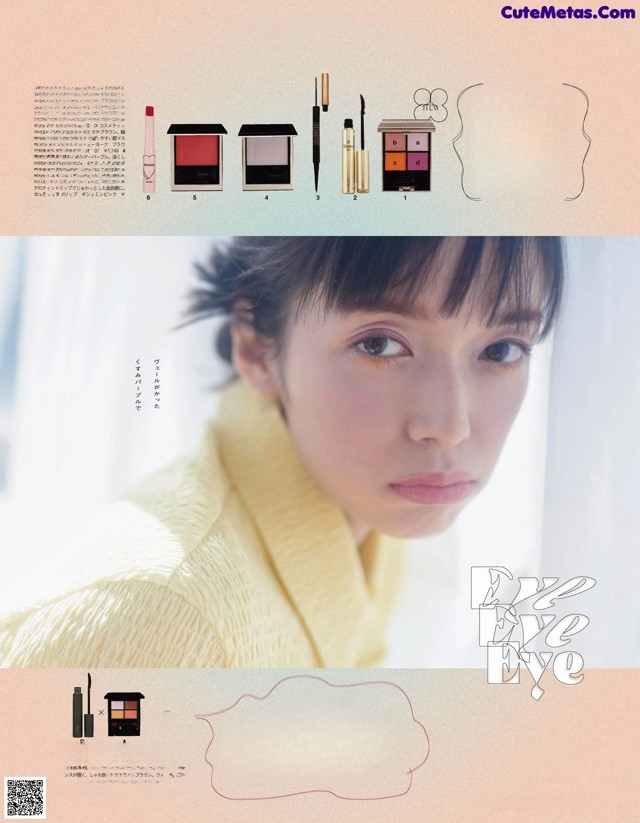A woman in a yellow sweater is looking at the camera.