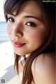 A woman with long brown hair is posing for a picture.