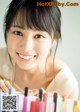 A woman holding a box of lipsticks in her hands.