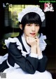 A woman in a maid outfit posing for a magazine.